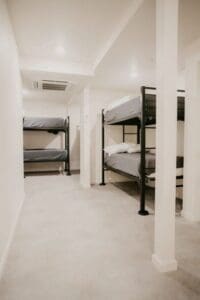 A small room with bunk beds in it.