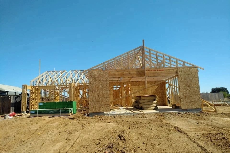 A house under construction with wood framing.