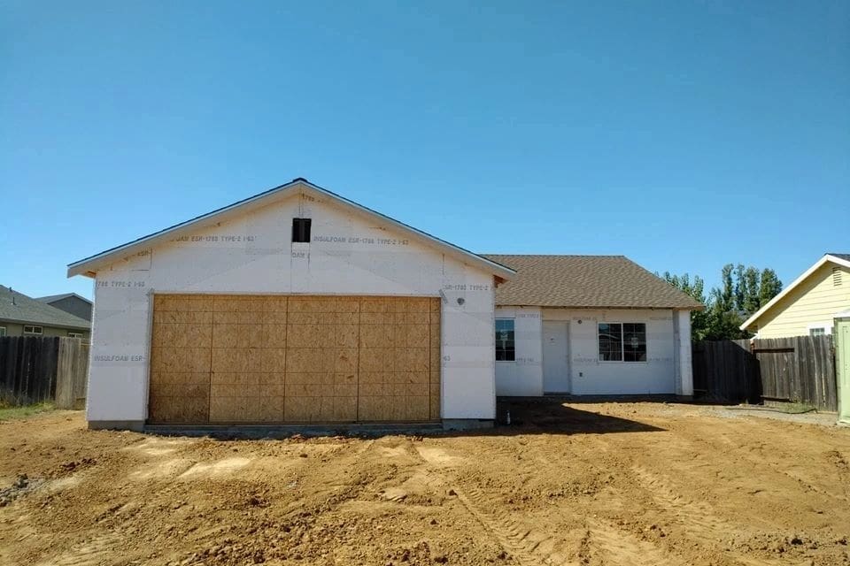 A house with a garage in front of it.