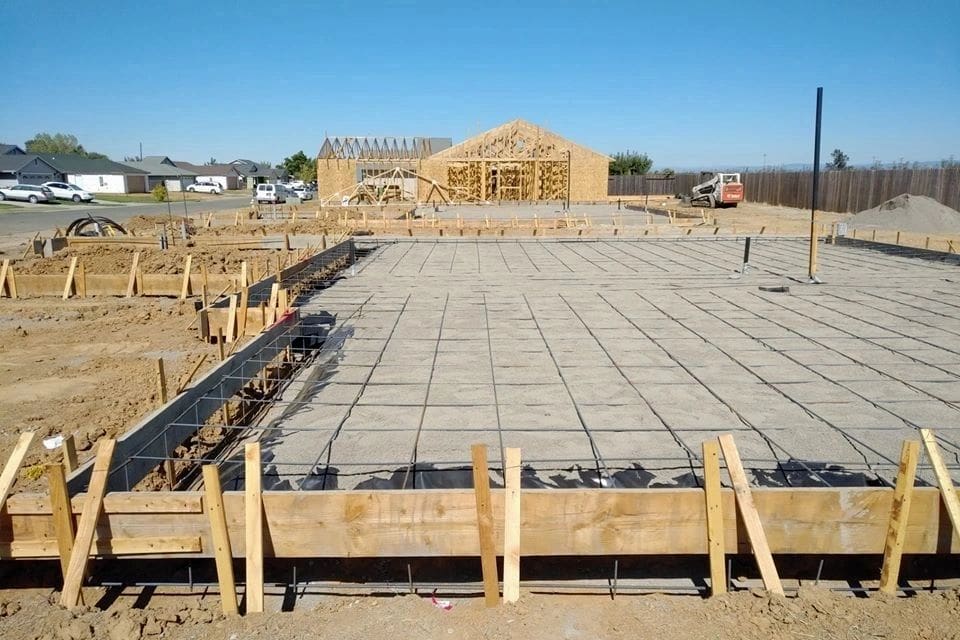 A house is being built on a concrete slab.